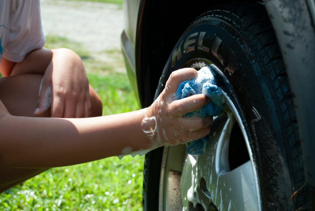 cleaning a car's tires before Wax and Polish