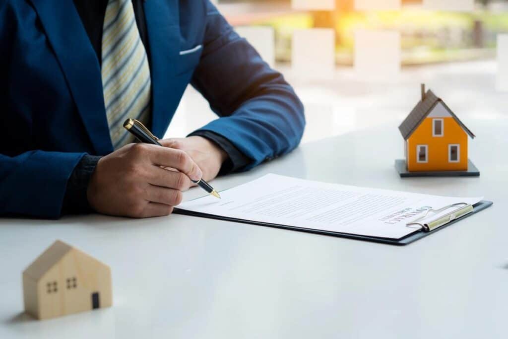 A man is reading a contract to purchase a home. 