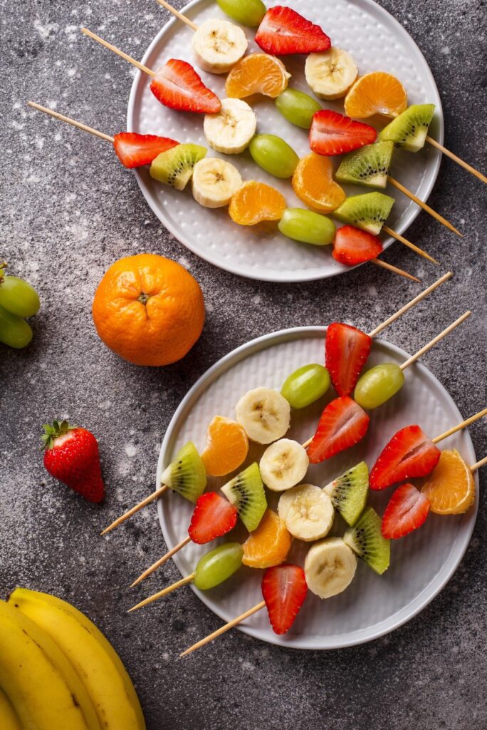 Crusty baguette slices are topped with creamy red pepper hummus and garnished with sliced chili and herbs. This savoury snack idea brings a bold, flavourful option to your entertaining table.