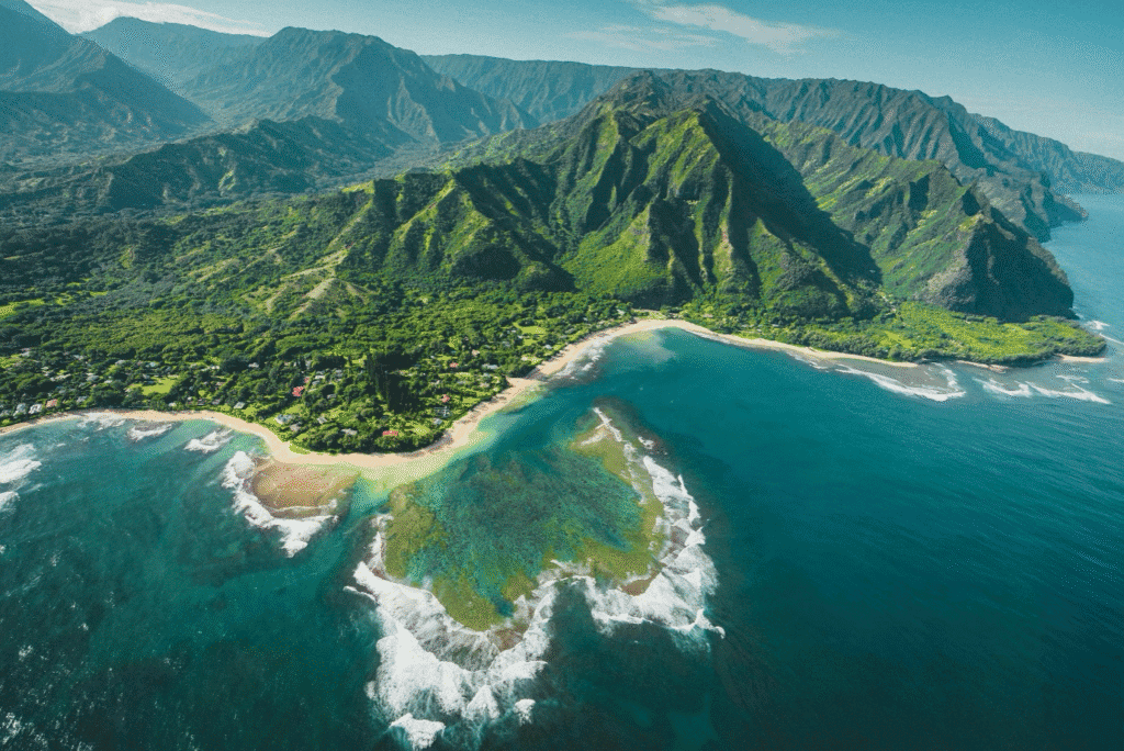 Aerial view over Hawaii with waves washing ashore. Depicts the benefits of solo travel in the pacific to embrace personal growth.